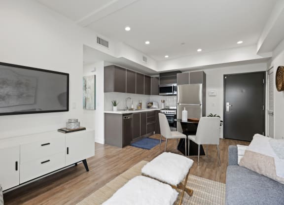 a living room with white walls and hardwood floors at The Fairfax Flats Apartments, Los Angeles, CA