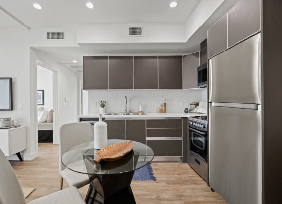 a kitchen and dining area in a 555 waverly unit at The Fairfax Flats Apartments, Los Angeles, CA