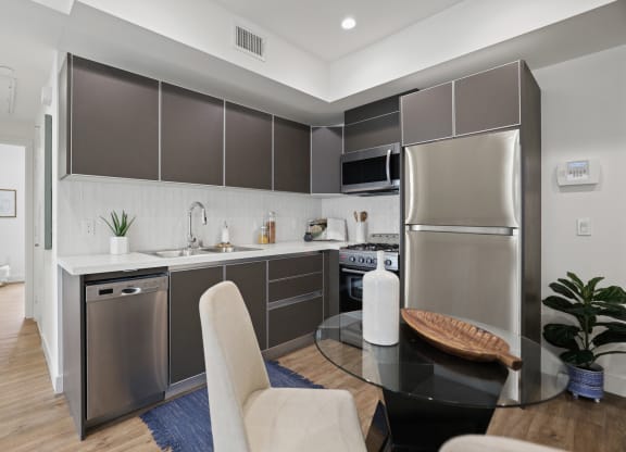a kitchen and dining area in a 555 waverly unit at The Fairfax Flats Apartments, California, 90019