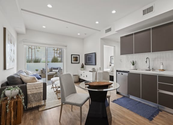a kitchen and living area in a 555 waverly unit at The Fairfax Flats Apartments, Los Angeles, CA