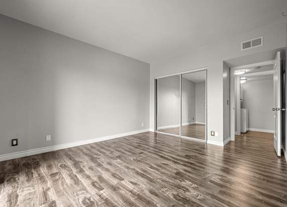 A room with wooden flooring and a sliding door at Lafayette Apartments, California