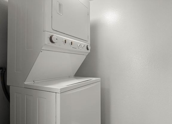 A white oven with a hood is mounted on a wall at Lafayette Apartments, Los Angeles, California