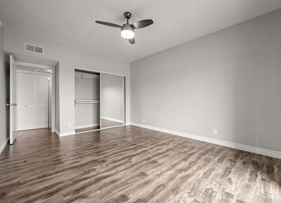 A room with a ceiling fan and wood flooring at Lafayette Apartments, Los Angeles 90019