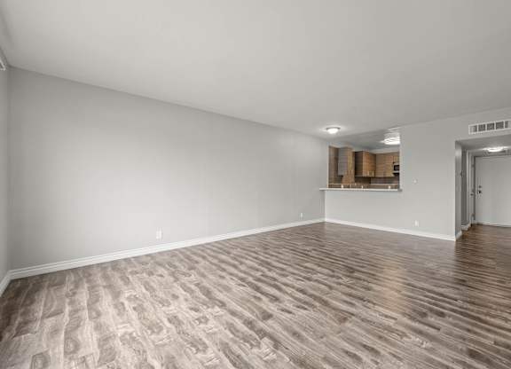 A room with wooden flooring and white walls at Lafayette Apartments, Los Angeles, California