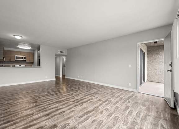 A room with wooden flooring and white walls at Lafayette Apartments, Los Angeles