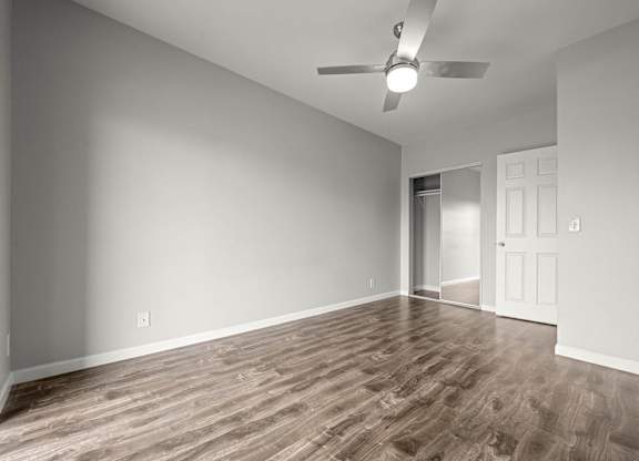 A room with a ceiling fan and wooden flooring at Lafayette Apartments, Los Angeles, CA, 90019