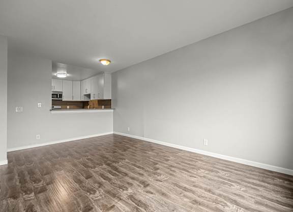 A room with a wooden floor and white walls at Lafayette Apartments, Los Angeles, California