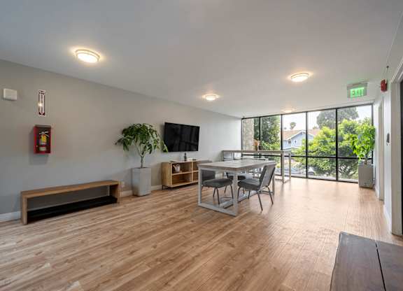 A room with wooden floors and a bench at Lafayette Apartments, Los Angeles, CA, 90019