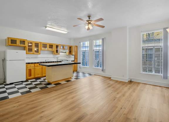 Kitchen with wooden cabinetry at The Langham Apartments, Los Angeles, CA, 90005
