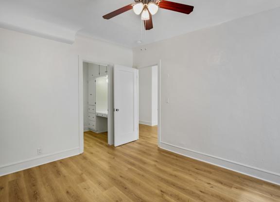 Spacious bedroom with ceiling fan at The Langham Apartments, Los Angeles, California
