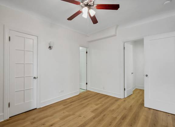 Spacious bedroom with wooden floor at The Langham Apartments, California