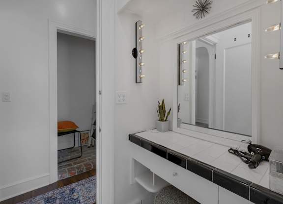Bathroom with a white vanity and a mirror at The Langham Apartments, Los Angeles, 90005