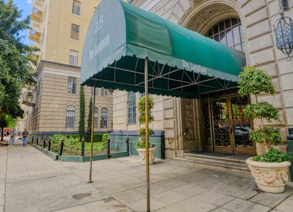 Green awning is covering a doorway at The Langham Apartments, Los Angeles, 90005