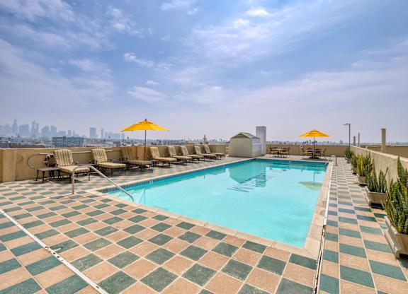 Swimming pool with tiled floor at The Langham Apartments, Los Angeles