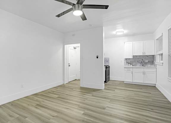 A room with a ceiling fan and lighting fixture.at Park Wilshire, California