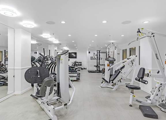 A gym with a variety of equipment including treadmills, weights, and exercise machines.at Park Wilshire, Los Angeles, CA 90057