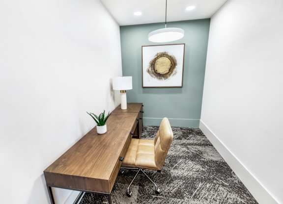 A room with a wooden table and a chair.