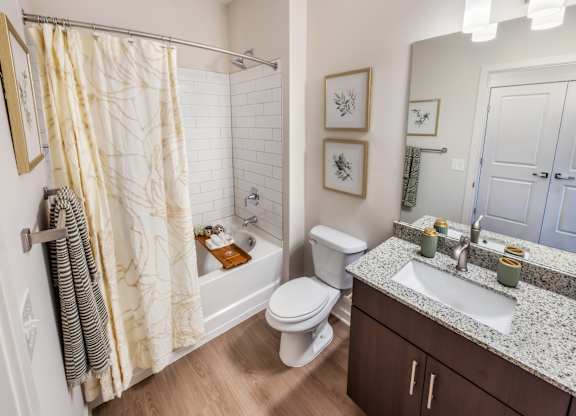 A bathroom with a toilet, sink, and shower.
