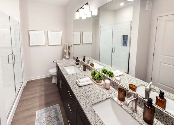 A bathroom with a large mirror, a sink, and a toilet.