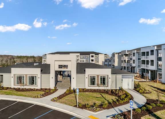 A building with a parking lot in front of it.