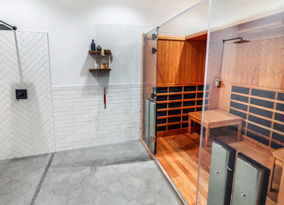 A bathroom with a walk-in shower and a wooden cabinet.