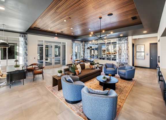A modern living room with a wooden ceiling and a variety of seating options.
