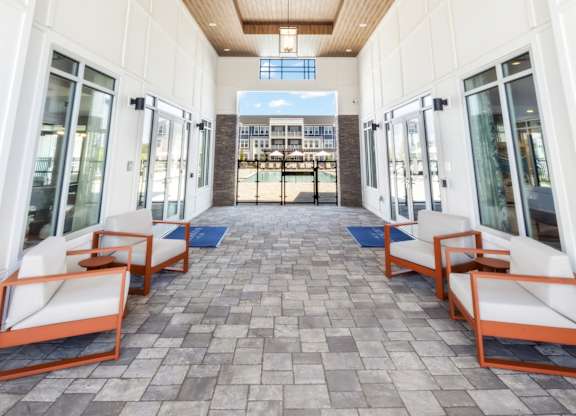 A long hallway with a wooden ceiling and tiled floor.