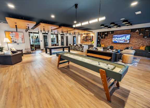 A room with a pool table and a bar.