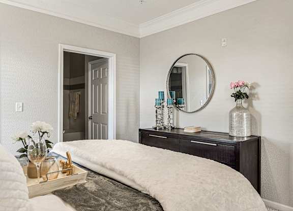 A bedroom with a large bed and a mirror above it at Echo at Lake Norman, Mooresville