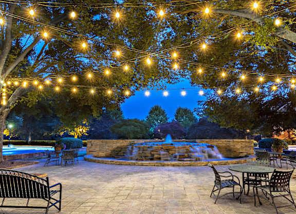A backyard with a pool and a table set for dining.