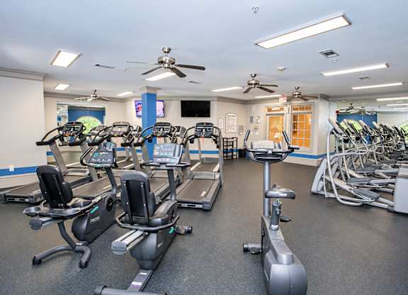 A gym with treadmills, exercise bikes, and elliptical machines.