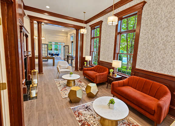A living room with a red couch and a white coffee table.