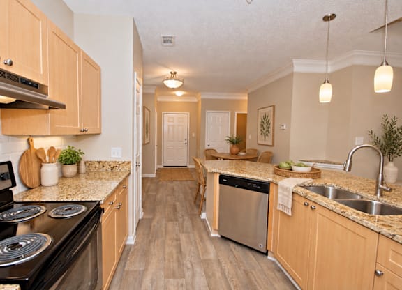 A kitchen with wooden cabinets and a black stove top oven.