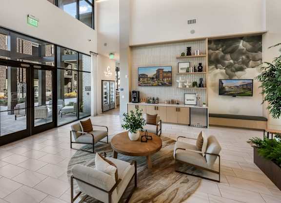 A living room with a couch, chairs, and a coffee table.