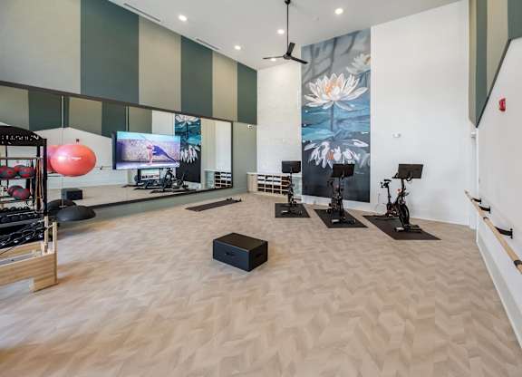 A yoga studio with a large mural on the wall.