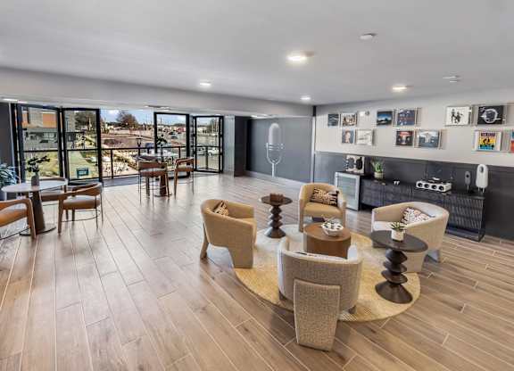 A living room with a wooden floor and a large window.