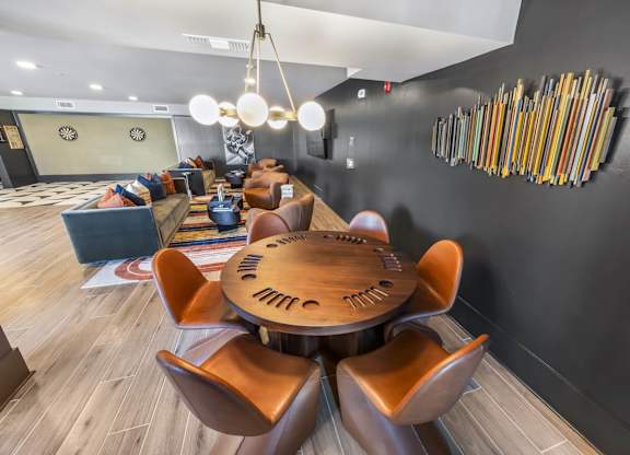 A modern dining room with a wooden table and chairs.