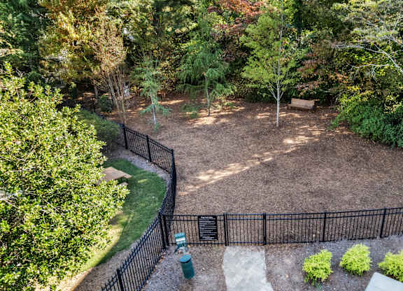 A backyard with a black fence and a green trash can at The Point at Perimeter, Georgia, 30338