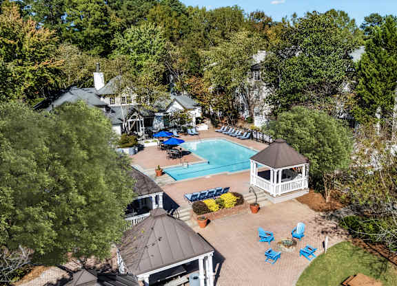 A pool surrounded by trees and a gazebo at The Point at Perimeter, Georgia, 30338