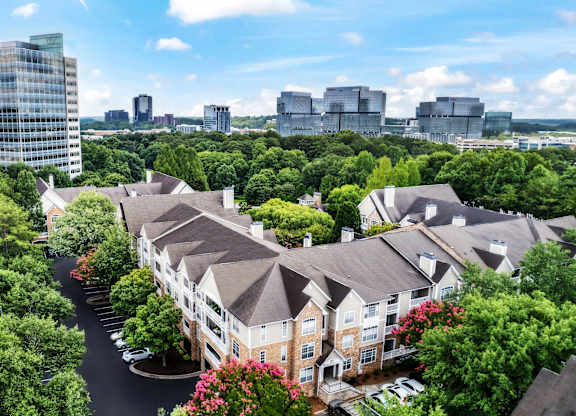 A view of a residential area with apartment buildings and trees.