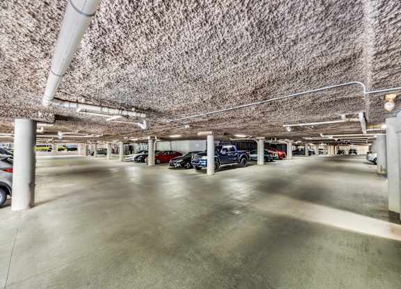 A parking garage with cars parked in it.
