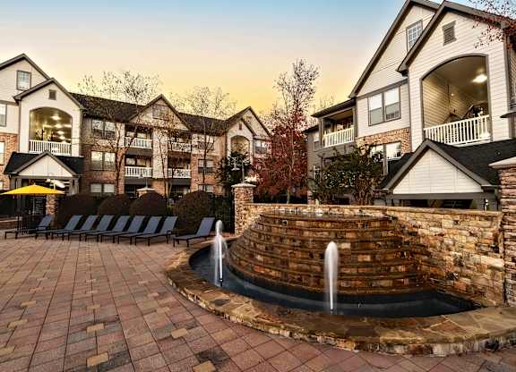 A large brick wall with a fountain in the middle of it.
