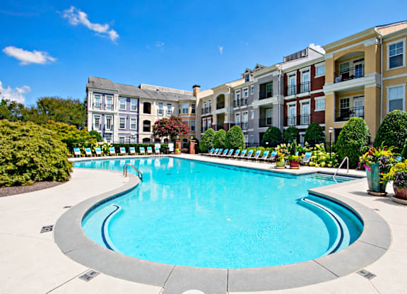 A swimming pool in front of apartment buildings.