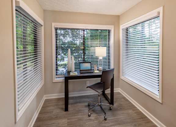a desk with a laptop computer and a lamp on top of it in a room with large at Seven Pines, Alpharetta, GA
