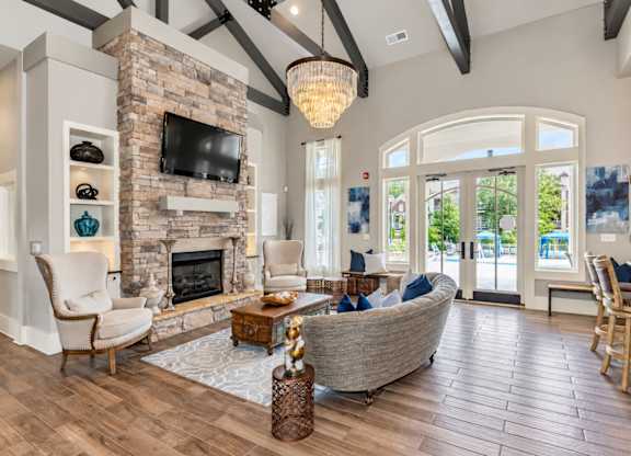 A living room with a stone fireplace and a large couch.