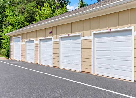 A row of white garage doors are closed.
