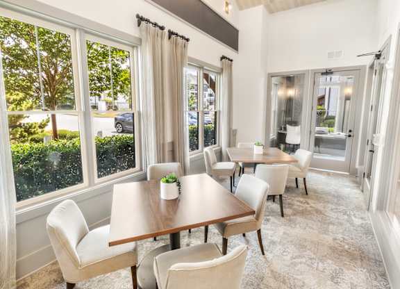 A dining room with a table and chairs.