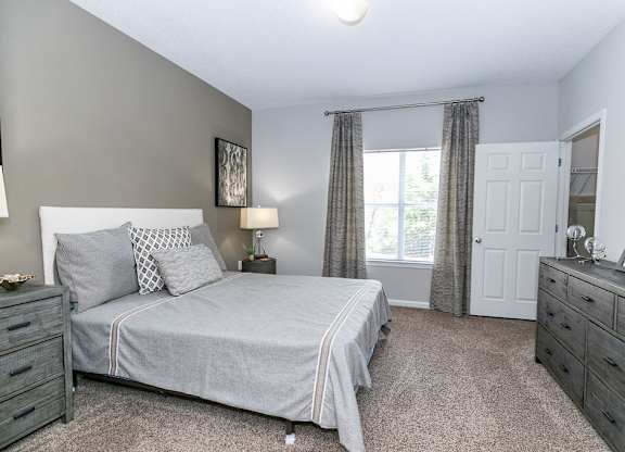 Bedroom With Expansive Windows at Villas at Hampton, Hampton