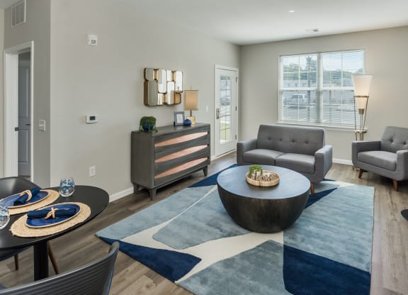 a living room with couches and a coffee table at Eden & Main 55+ Apartments, Connecticut