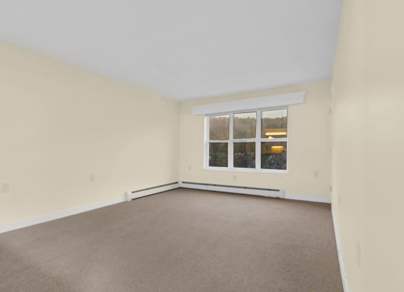 the living room of an empty house with a window